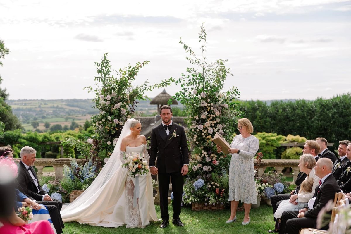 A bride and groom smiling at each other as they make their promises
